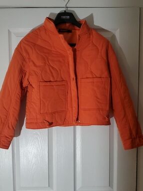 Bright orange cropped quilted puffer jacket